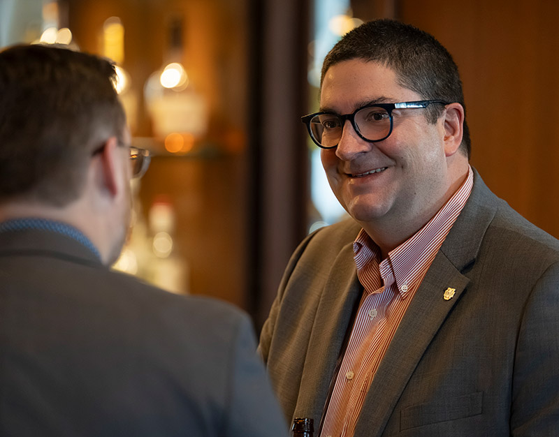Two men talking and smiling